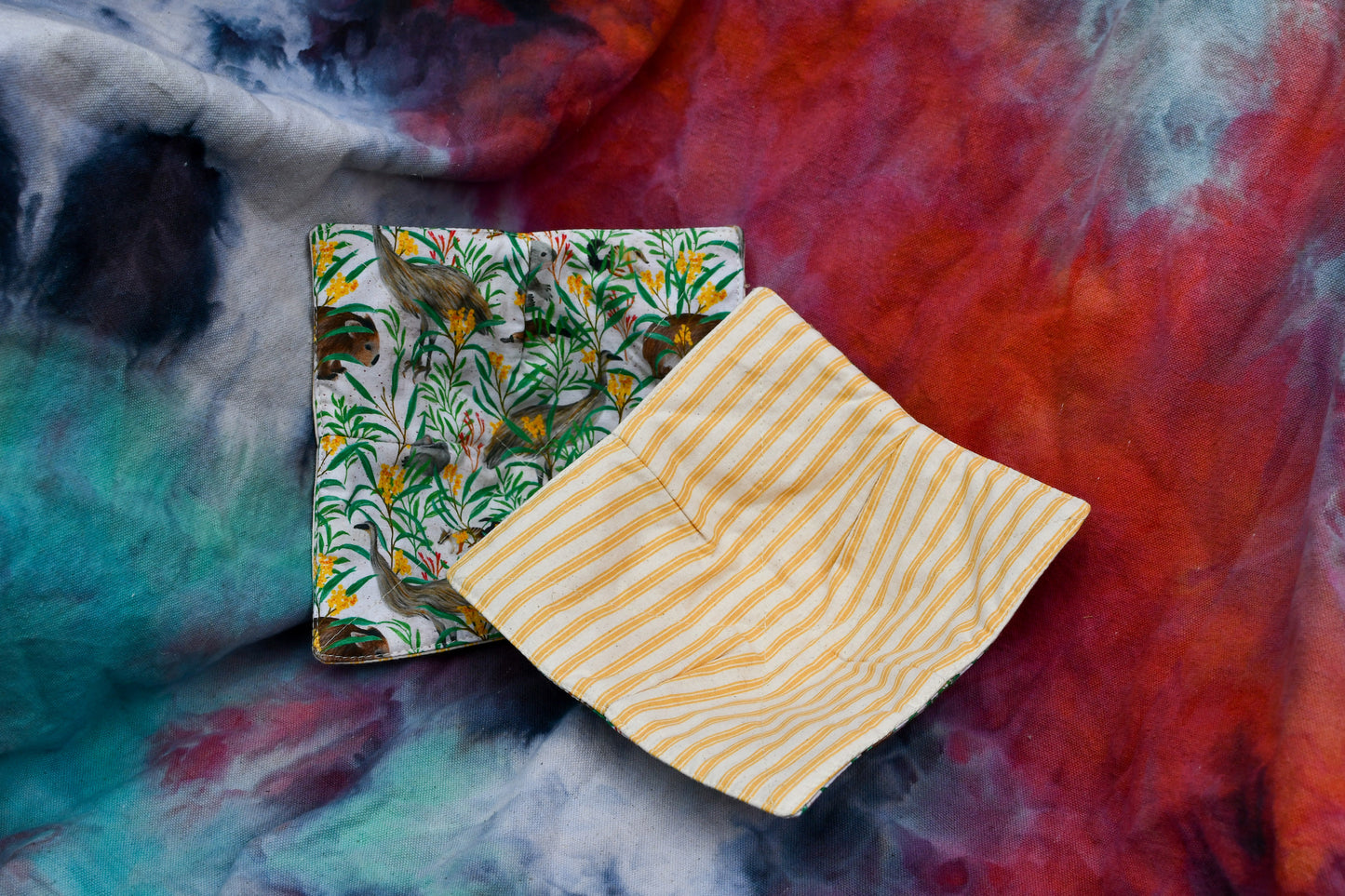 Bowl cosy using Australian animal fabrics with emus wombats and koalas with contrasting yellow and neutral striped ticking as lining.