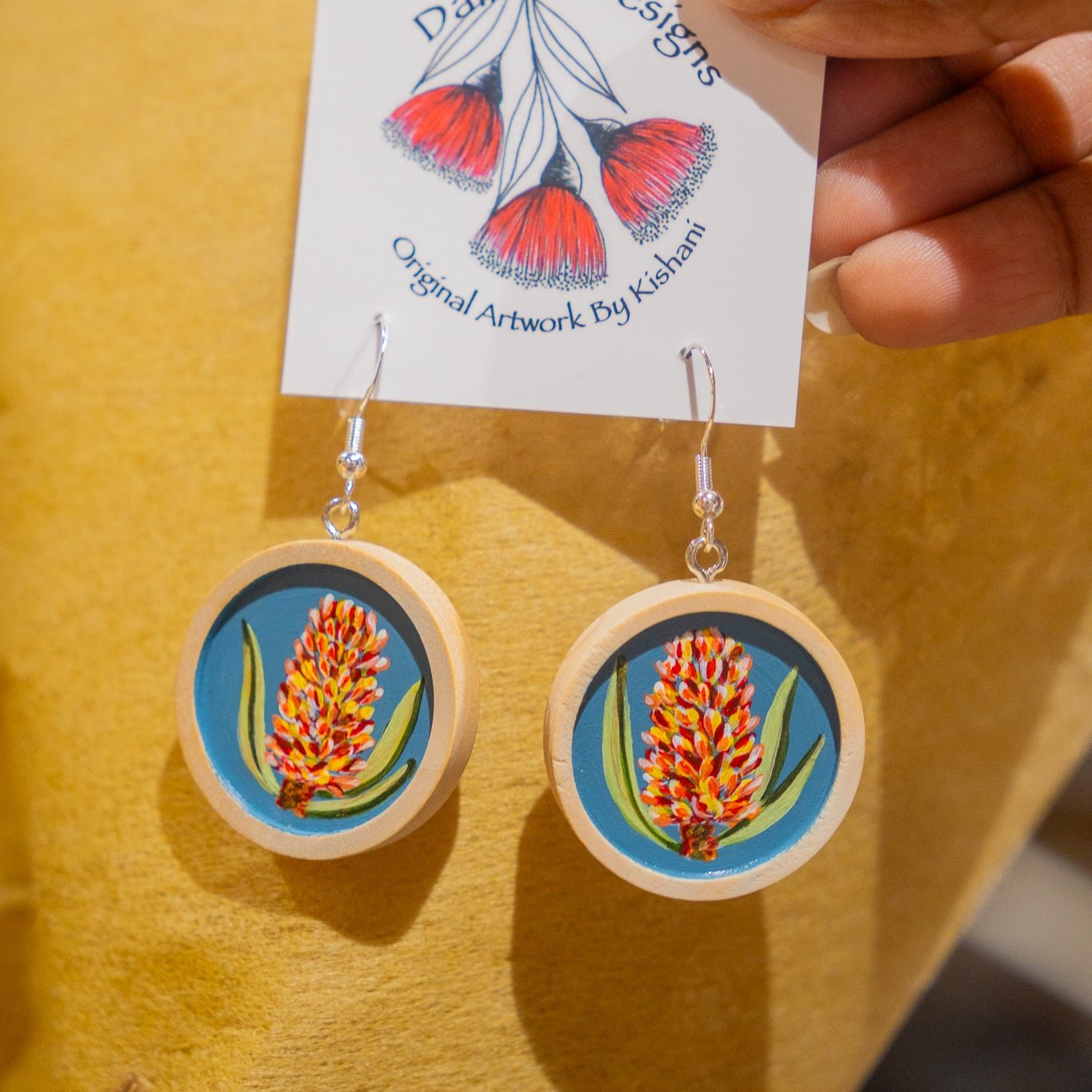 Wooden cabachon dangle earrings painted with banksias