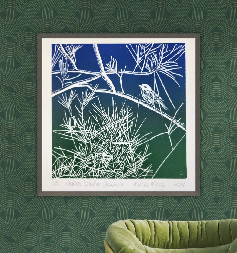 Hand coloured lino cut artwork of a golden whistler framed and hanging on a wall