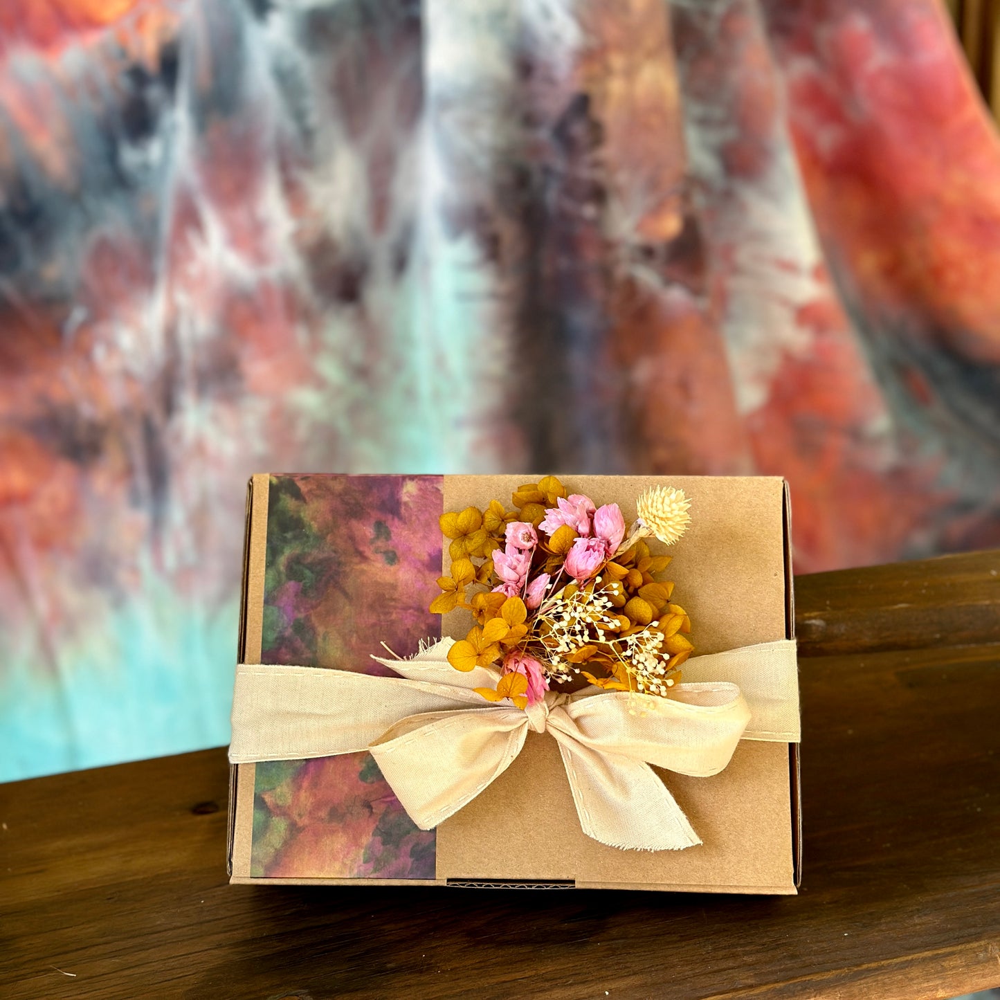 Gift box packaging with ribbon and mini bunch of dried flowers
