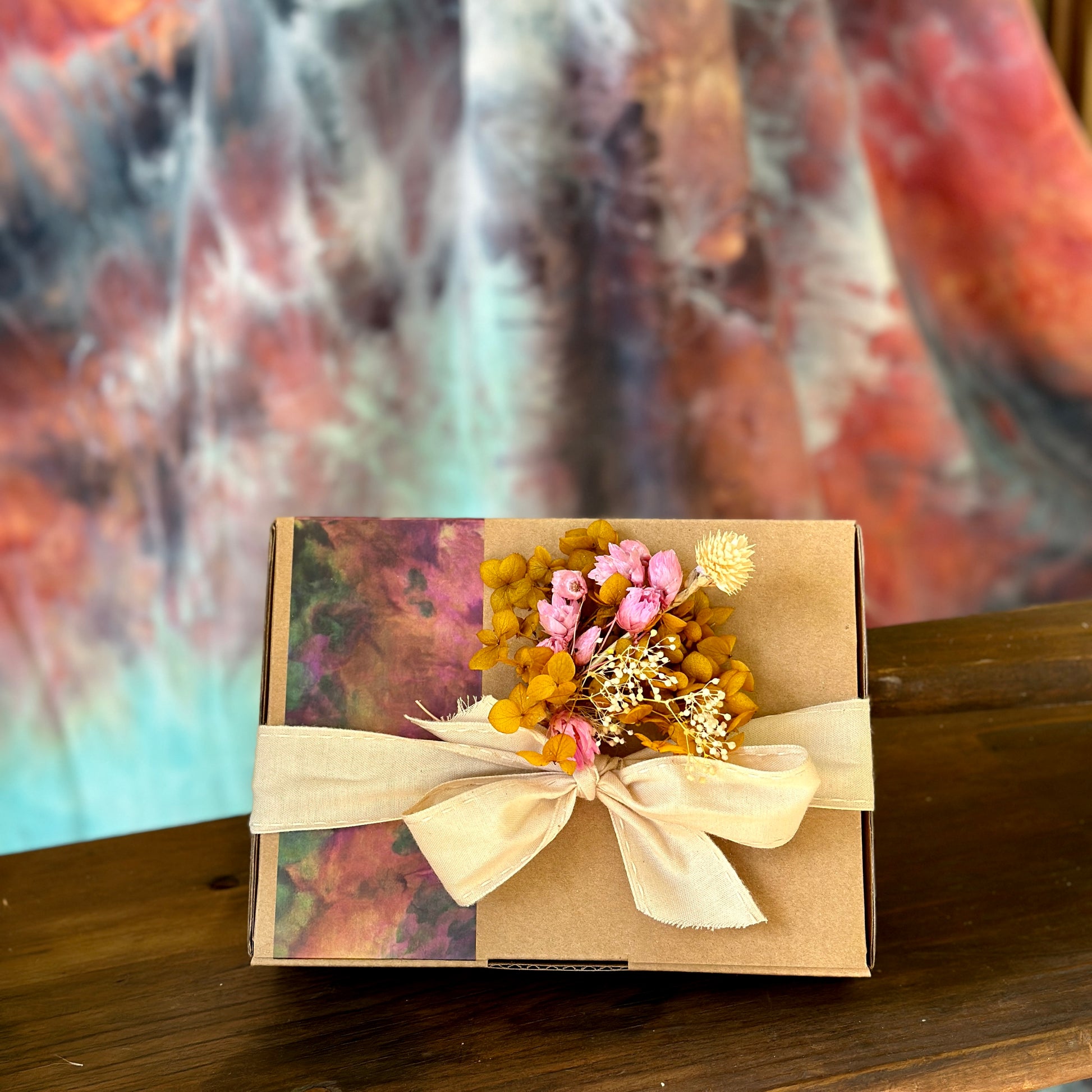 Gift box packaging with ribbon and mini bunch of dried flowers