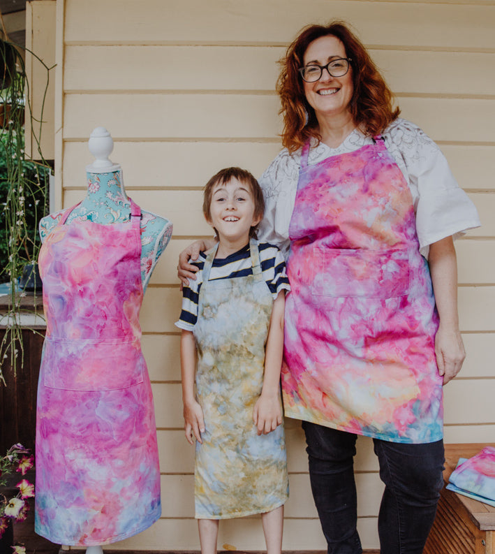 Mother and son wearing ice dyed aprons