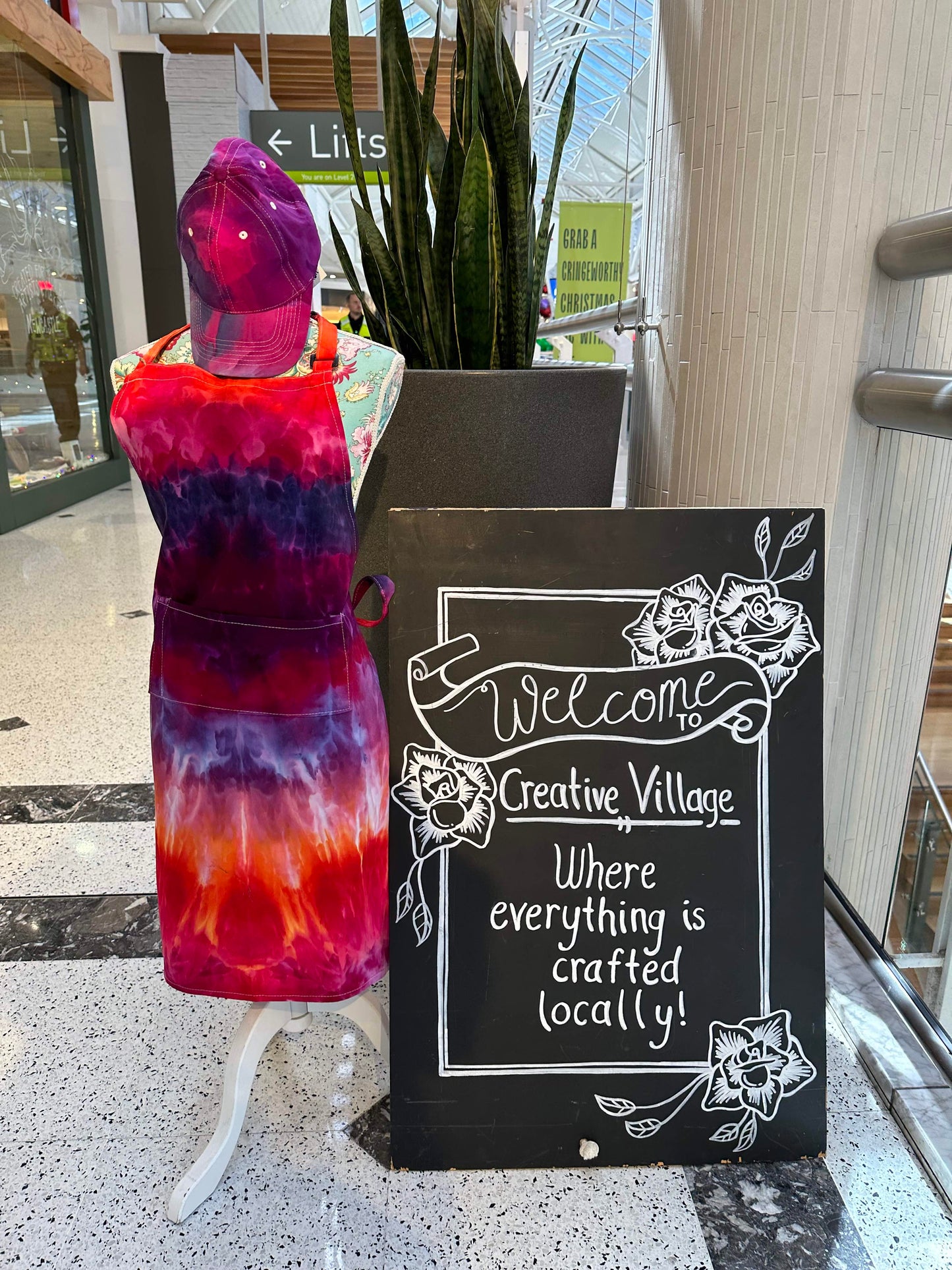 Creative village newcastle sign and mannikin with an ice dyed apron