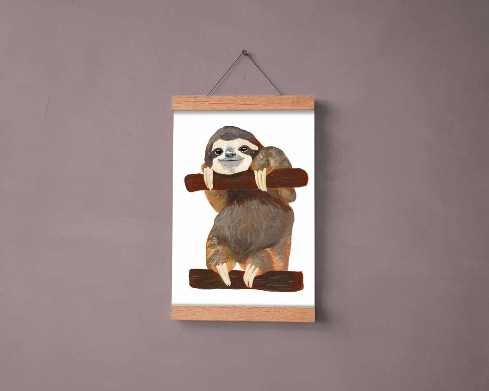 Smiling sloth on logs artwork hanging on a wall.