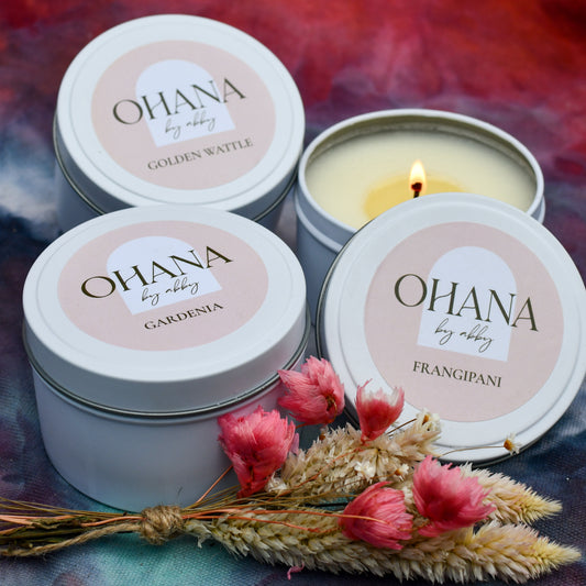 three floral scented candles in white tins with a mini bunch of dried flowers as a gift pack